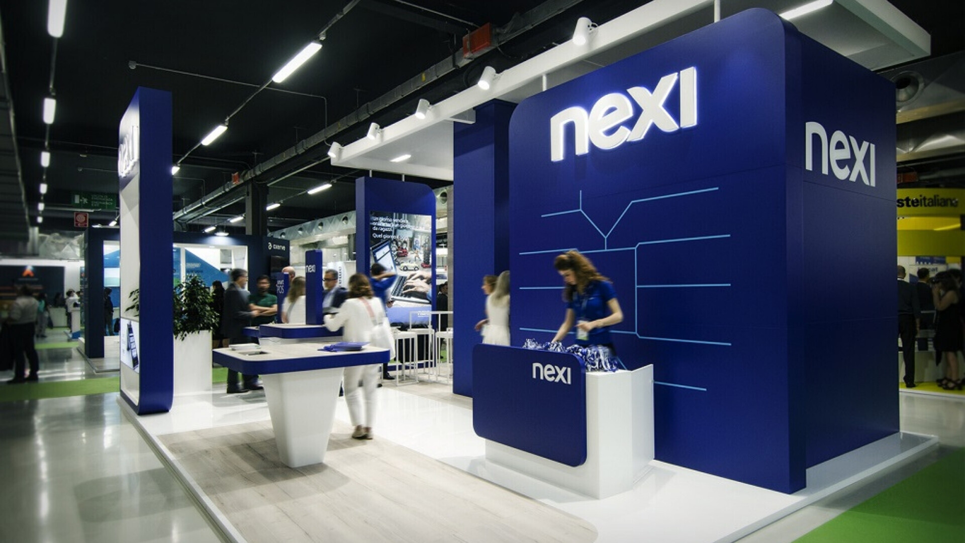 Stand Nexi allestito per eventi o fiere, con materiale promozionale.