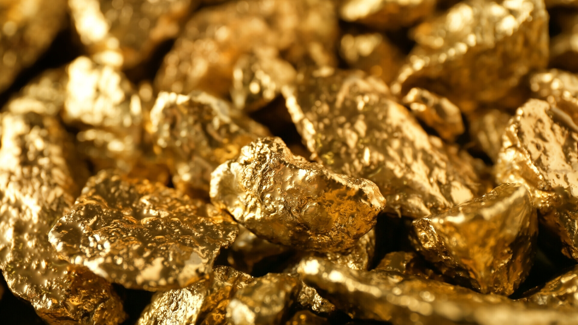 Gemme d'oro Pietre preziose e piccoli lingotti d’oro illuminati da luce calda